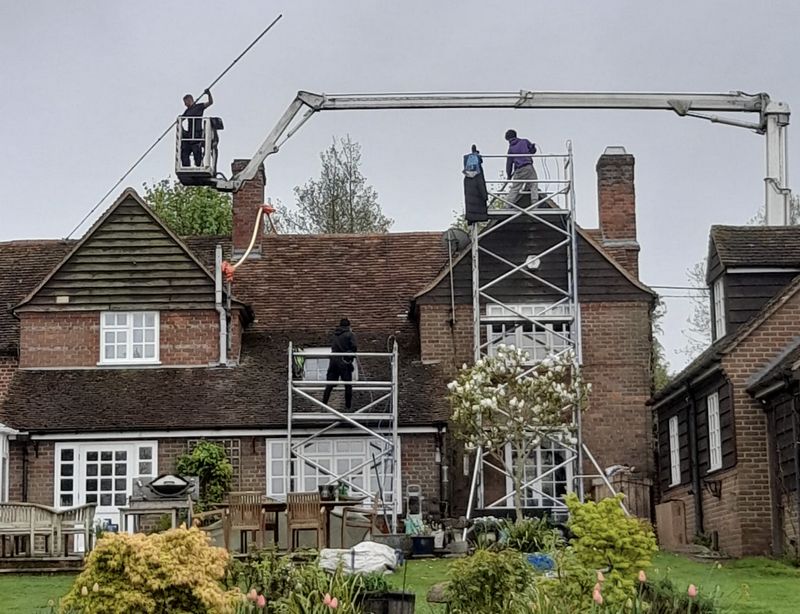 The Roof Moss Cleaners using cherry picker and scaffolding to clean roof safely and professionally in Lyneham, Wiltshire